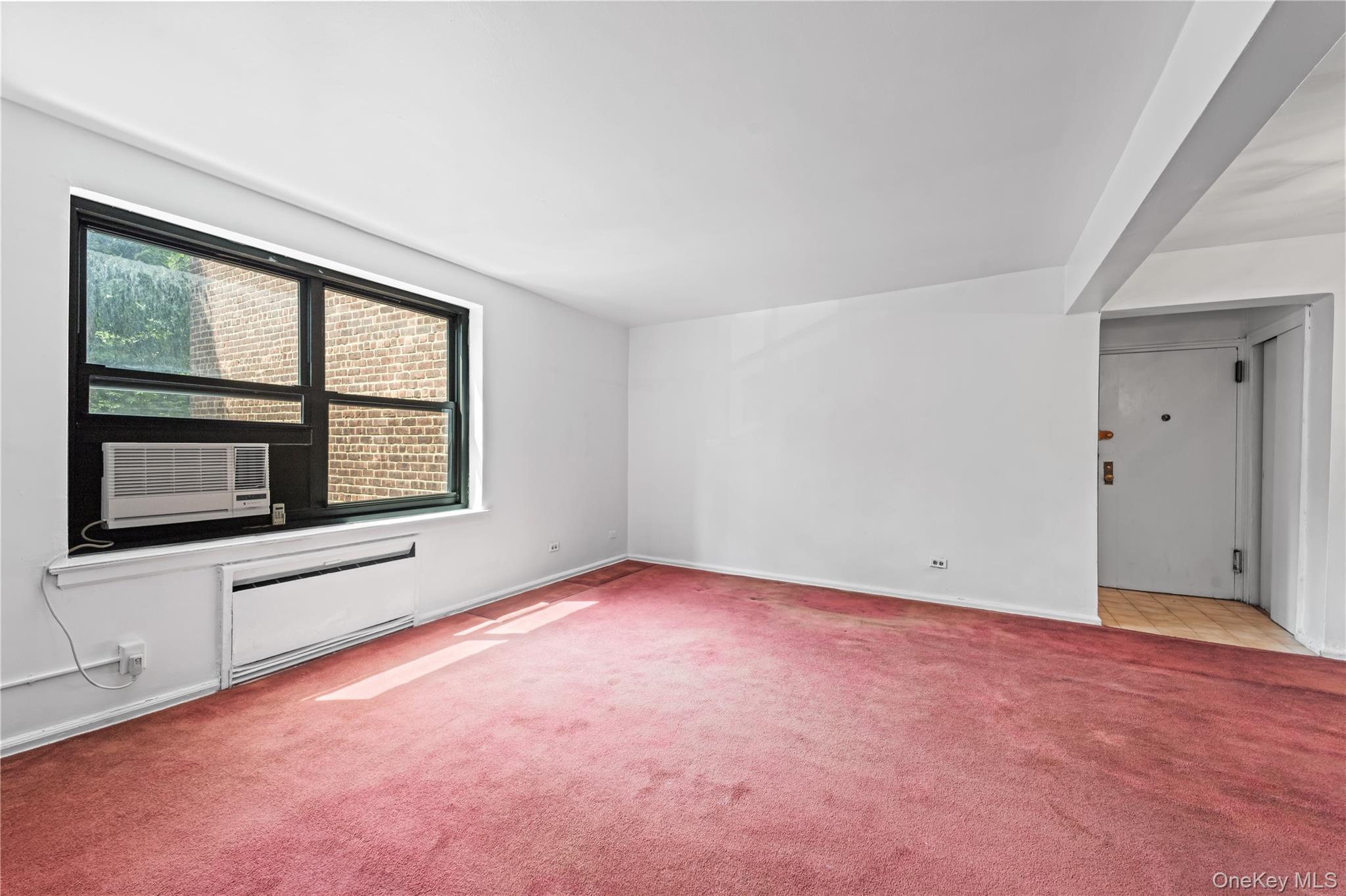 73-45 210th Street, Unit 3F Queens, NY 11364 - Photo 7 of 15 an empty room with windows