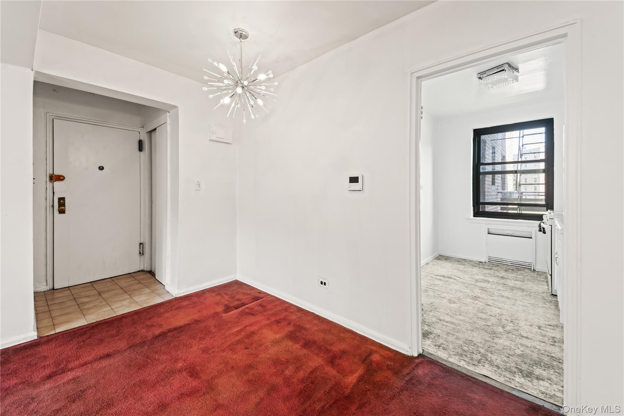 73-45 210th Street, Unit 3F Queens, NY 11364 - Photo 9 of 15 wooden floor in an empty room with a window
