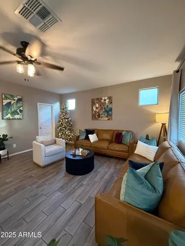 a living room with furniture and a potted plant