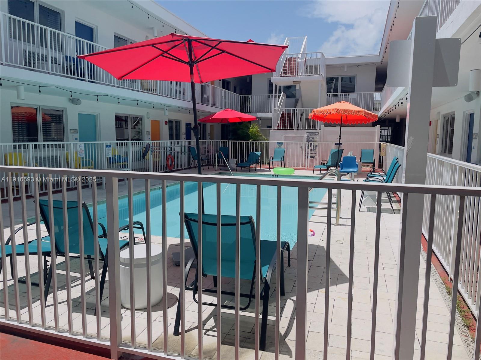 7310 Harding Avenue, Unit 318 Miami Beach, FL 33141 - Photo 2 of 6 a view of a balcony with furniture and wooden deck