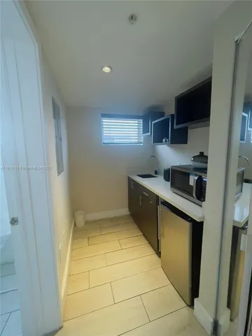 a kitchen with stainless steel appliances granite countertop a sink and cabinets