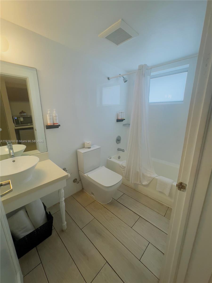 7310 Harding Avenue, Unit 318 Miami Beach, FL 33141 - Photo 6 of 6 a bathroom with a sink toilet and shower