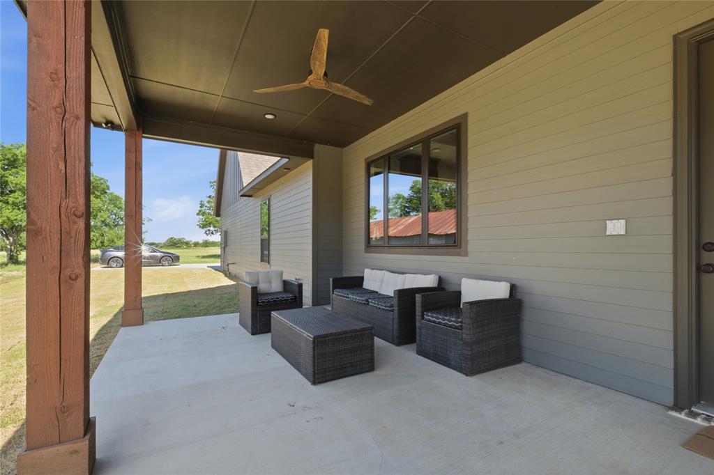 958 Cedar Mills Road Gordonville, TX 76245 - Photo 33 of 40 a living room with furniture and a floor to ceiling window