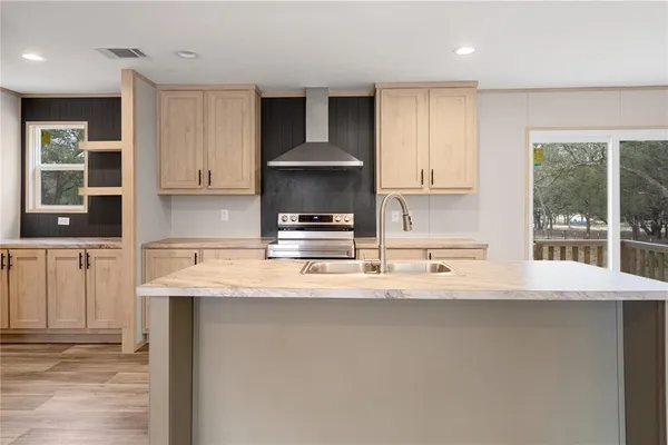 a kitchen with stainless steel appliances granite countertop a sink and stove top oven