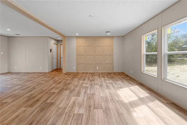 a view of living room kitchen with stainless steel appliances cabinets