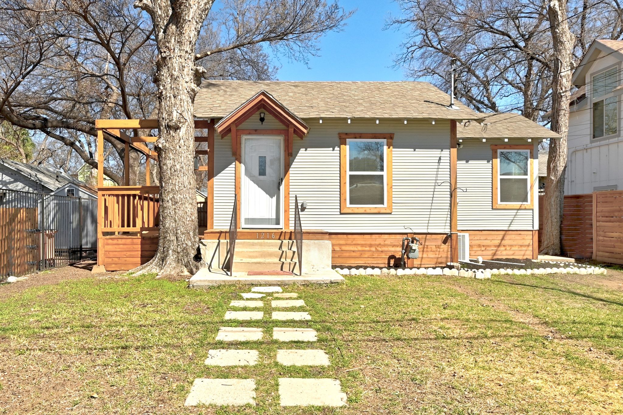1216 Holly Street Austin, TX 78702 - Photo 1 of 1 Bungalow-style house featuring a shingled roof and a deck