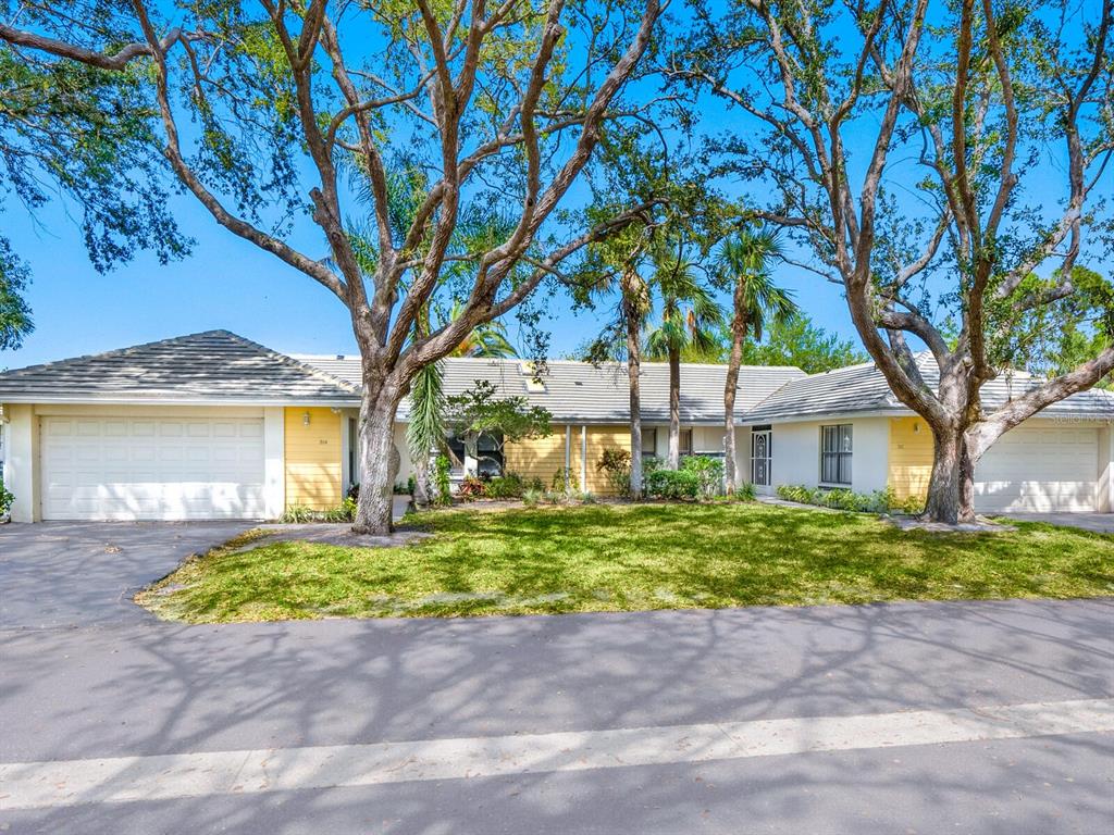 314 Pembroke Drive, Unit 200 Venice, FL 34293 - Photo 1 of 37 a front view of a house with a garden