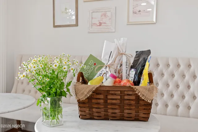 a view of a dining room with furniture a chandelier and wooden floor