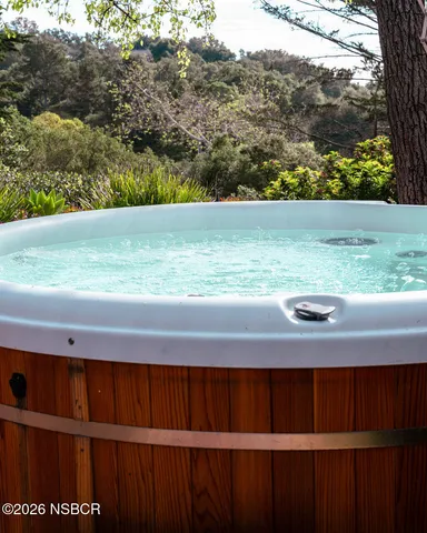a bathroom with a double vanity sink a mirror a bathtub and shower