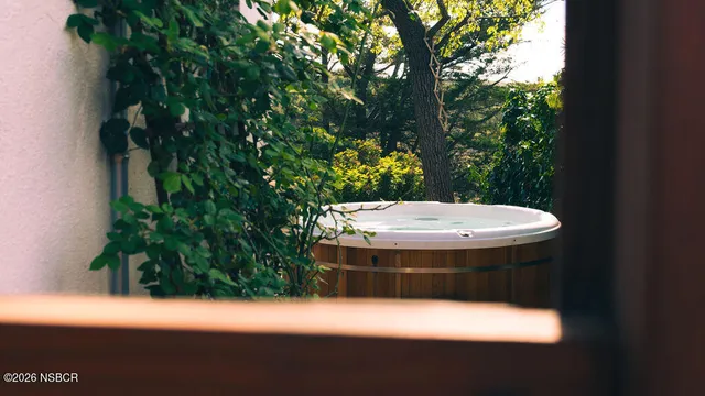 a bathroom with a tub sink and mirror