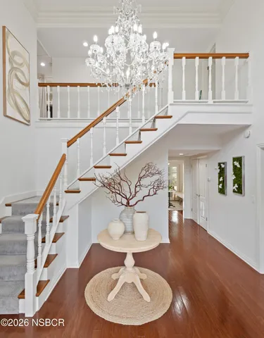 a view of entryway and hall with wooden floor