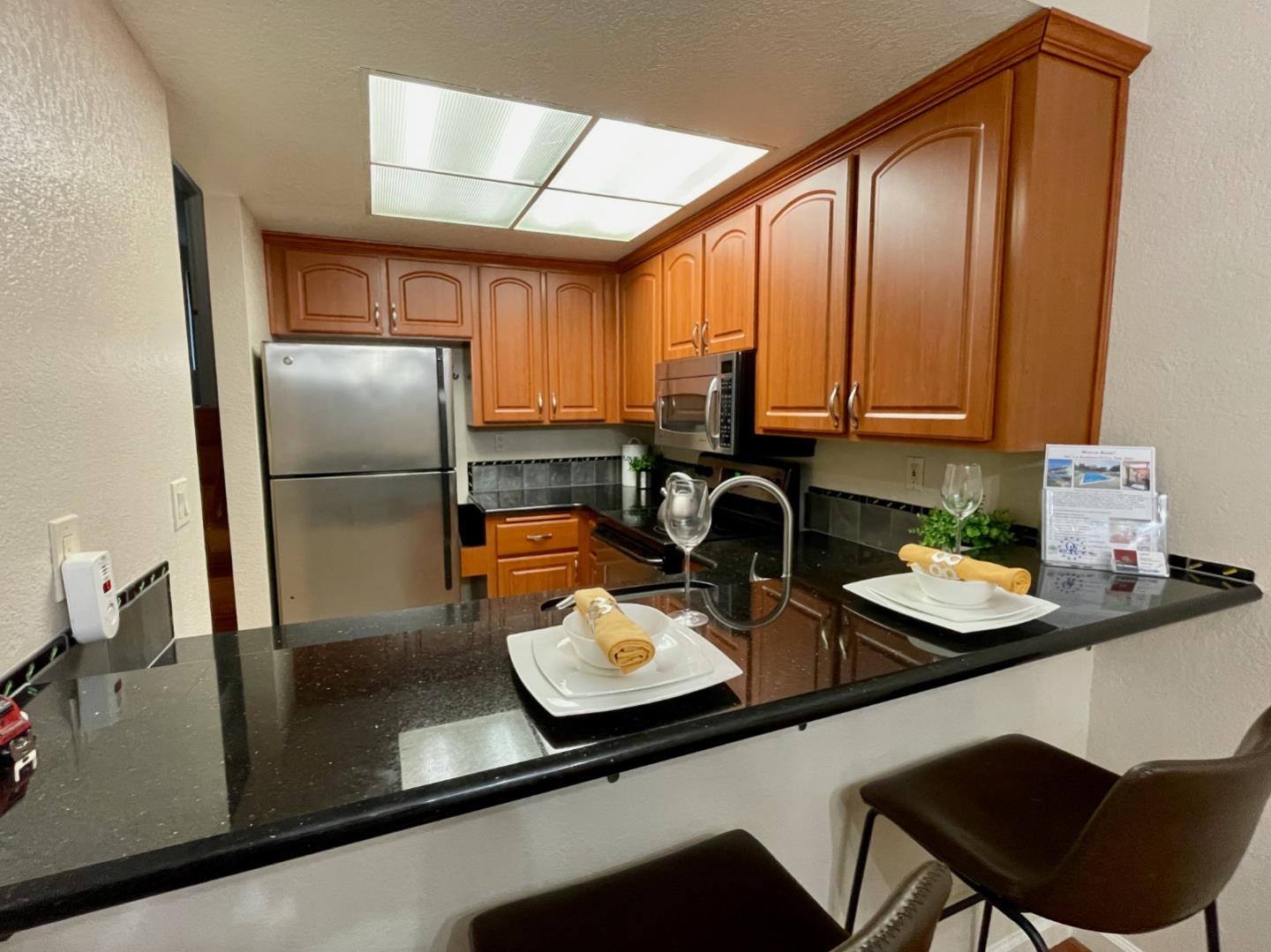 862 La Barbera Drive San Jose, CA 95126 - Photo 4 of 29 a kitchen with a refrigerator and a stove top oven