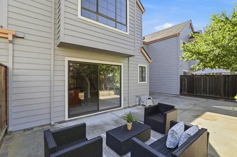 a view of a patio with couple of couches and deck