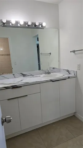 a bathroom with a sink and mirror