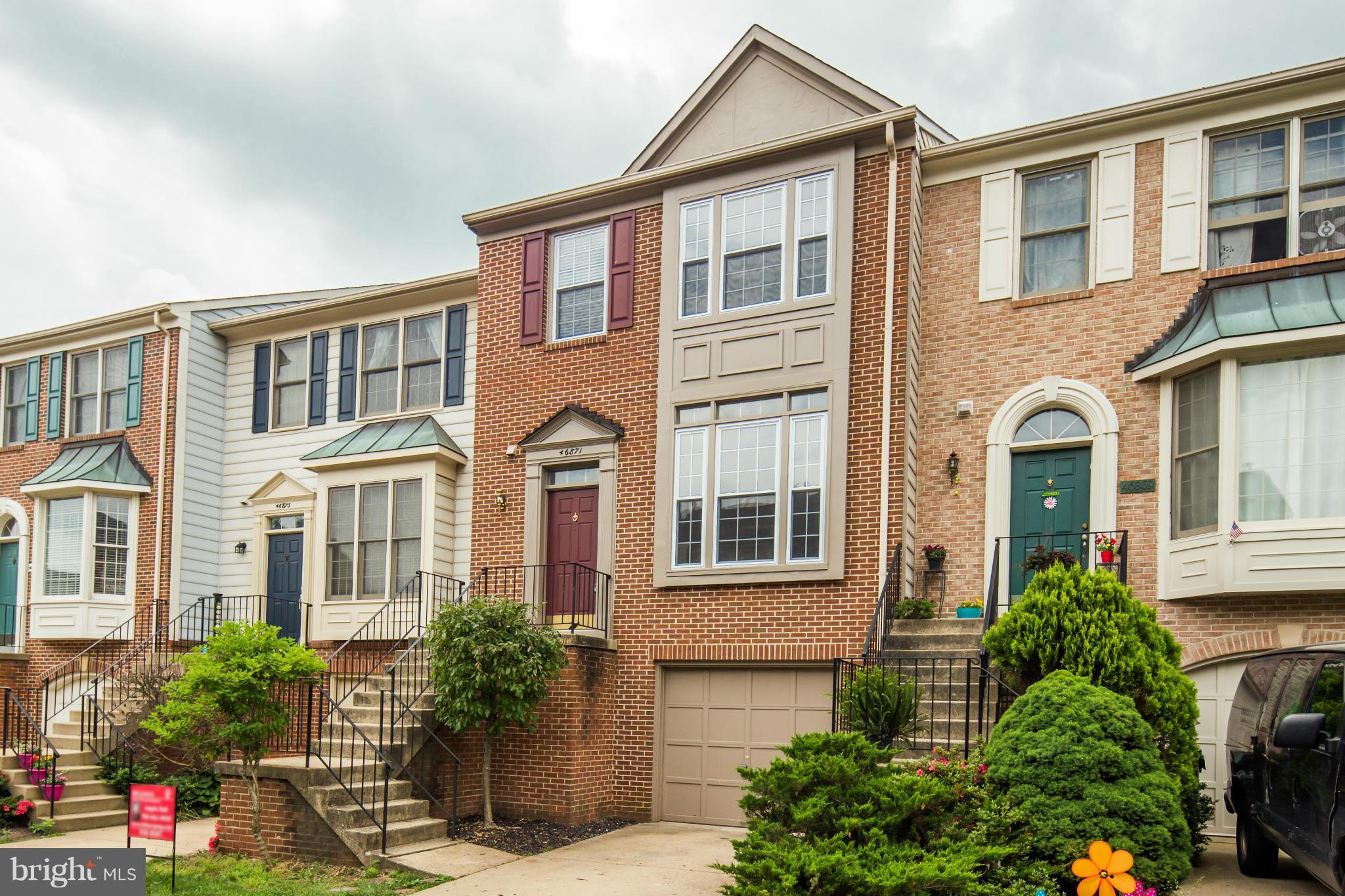 46871 Rabbitrun Terrace Sterling, VA 20164 - Photo 1 of 30 a front view of a house with a garden