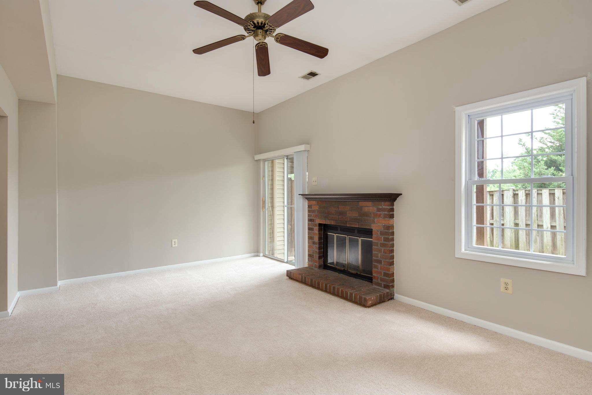 46871 Rabbitrun Terrace Sterling, VA 20164 - Photo 22 of 30 an empty room with windows fireplace and fan