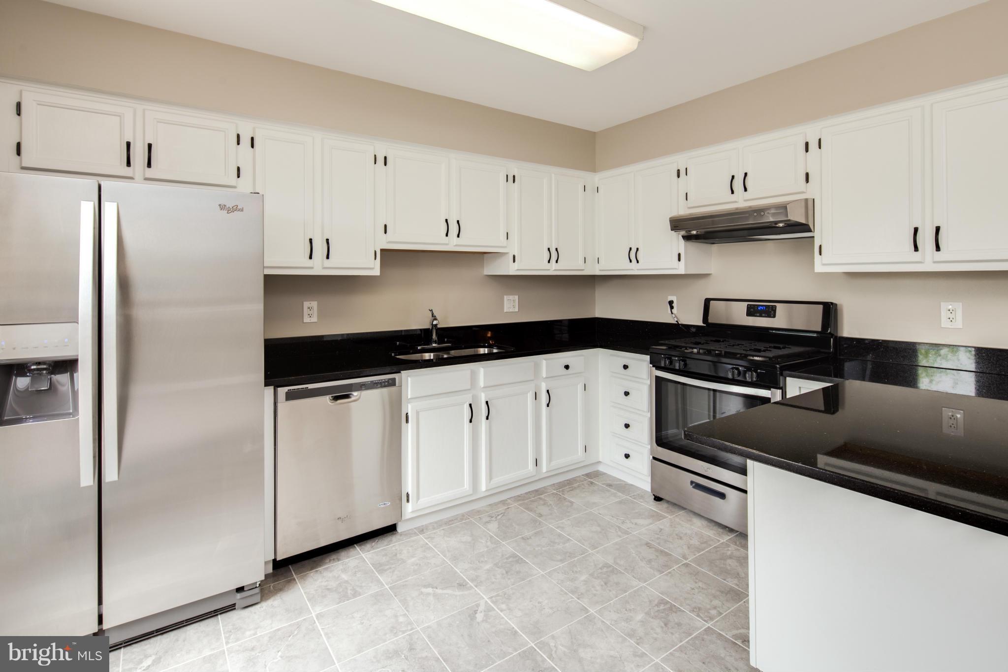 46871 Rabbitrun Terrace Sterling, VA 20164 - Photo 8 of 30 a kitchen with cabinets and stainless steel appliances