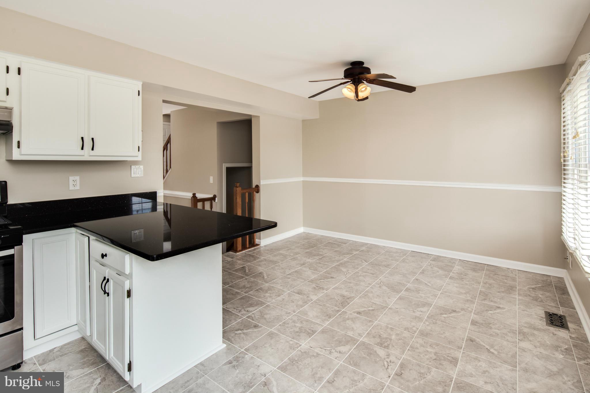 46871 Rabbitrun Terrace Sterling, VA 20164 - Photo 9 of 30 a kitchen with granite countertop a sink and cabinets