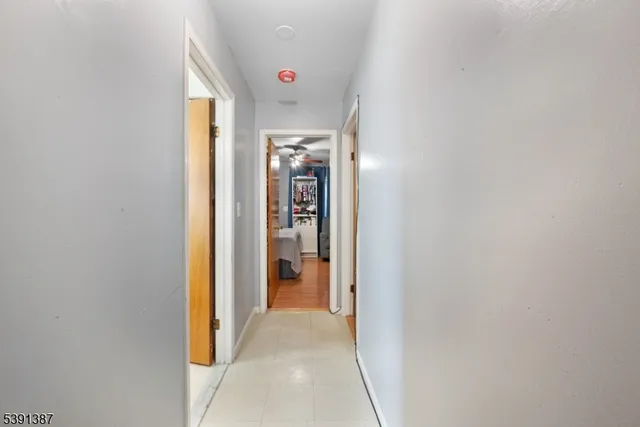 a view of a hallway with wooden shelves
