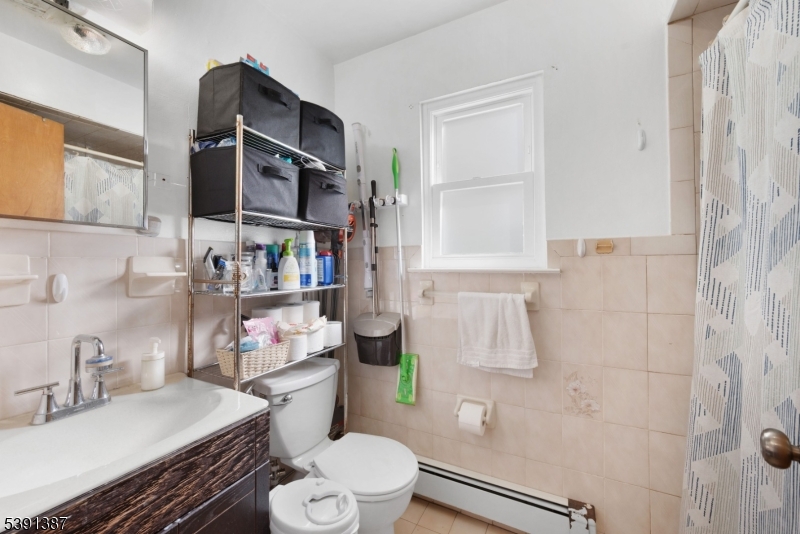 566 2nd Avenue Elizabeth, NJ 07202 - Photo 12 of 38 a bathroom with a sink toilet vanity and window