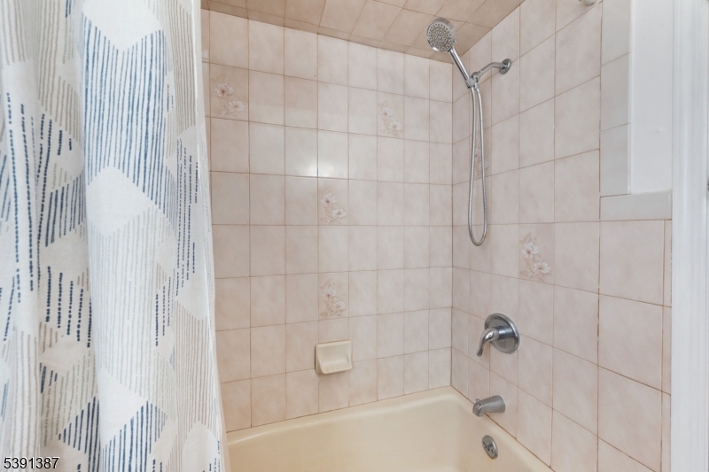 566 2nd Avenue Elizabeth, NJ 07202 - Photo 13 of 38 a bathroom with a shower and a bathtub