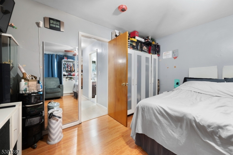 566 2nd Avenue Elizabeth, NJ 07202 - Photo 17 of 38 a spacious bedroom with a bed and a dresser