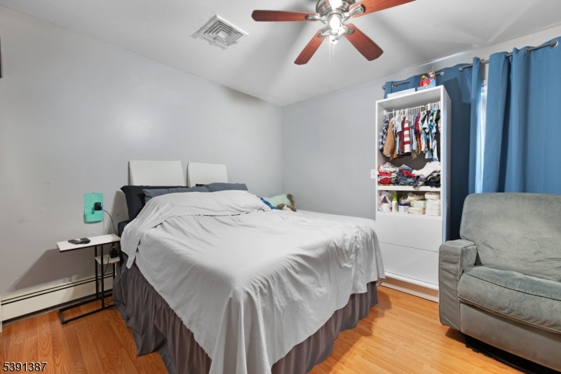 566 2nd Avenue Elizabeth, NJ 07202 - Photo 18 of 38 a spacious bedroom with a bed and a couch