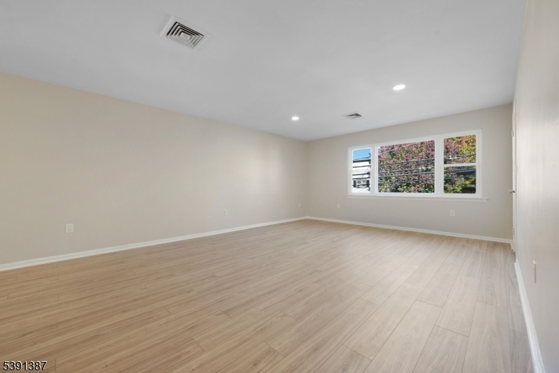 566 2nd Avenue Elizabeth, NJ 07202 - Photo 19 of 38 wooden floor in an empty room with a window