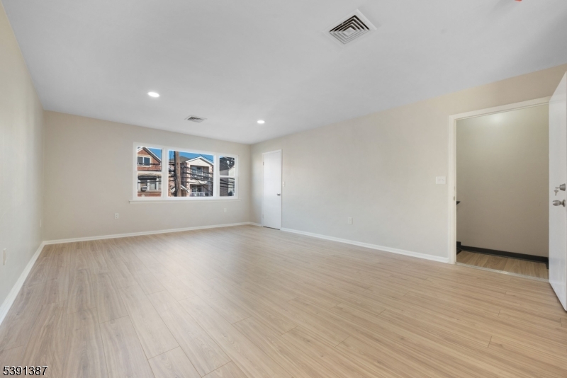 566 2nd Avenue Elizabeth, NJ 07202 - Photo 20 of 38 a view of an empty room with a window and wooden floor