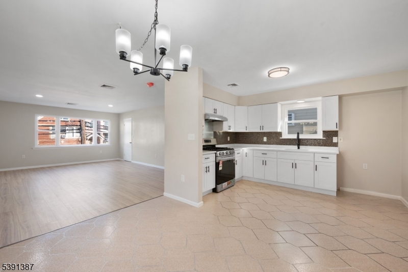 566 2nd Avenue Elizabeth, NJ 07202 - Photo 24 of 38 a kitchen with granite countertop a stove a sink and a refrigerator