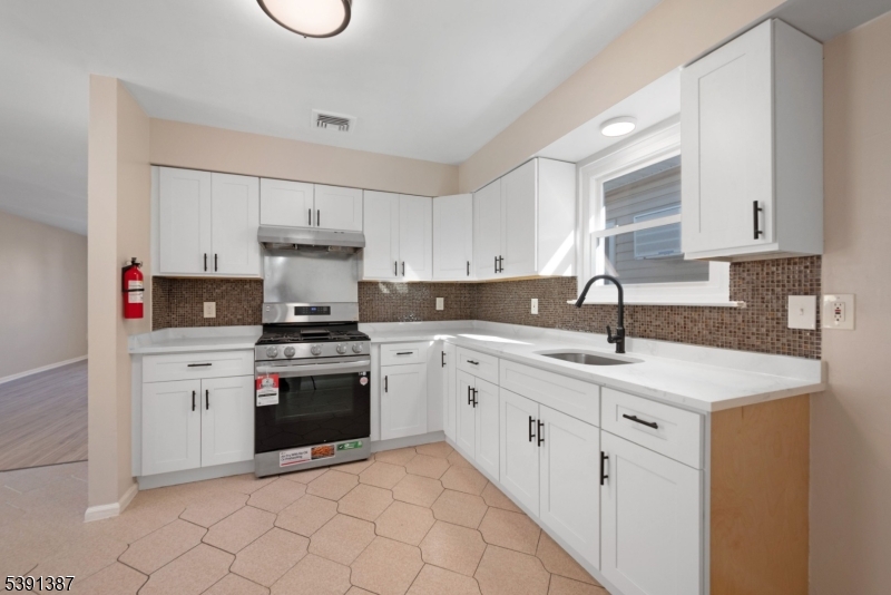 566 2nd Avenue Elizabeth, NJ 07202 - Photo 26 of 38 a kitchen with cabinets appliances a sink and a counter top space