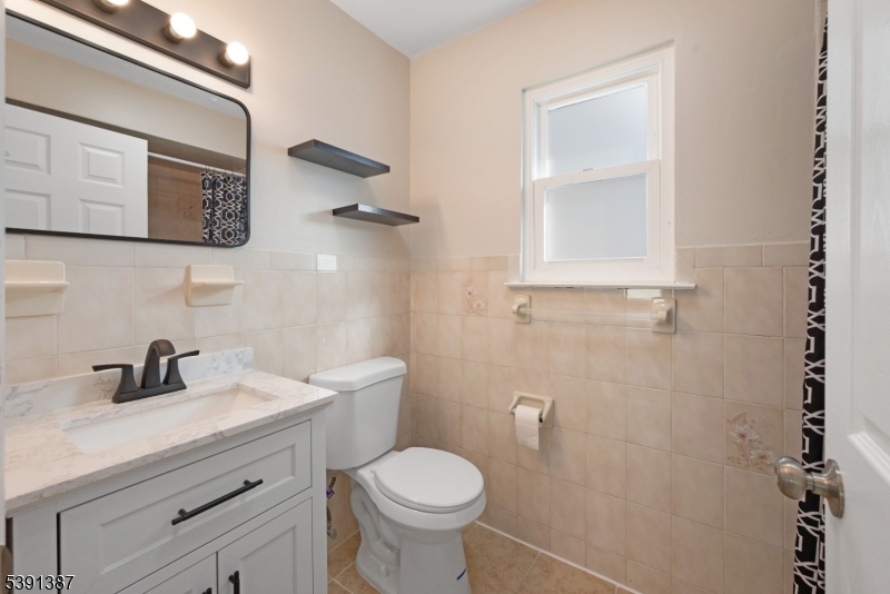 566 2nd Avenue Elizabeth, NJ 07202 - Photo 29 of 38 a bathroom with a toilet a sink and mirror