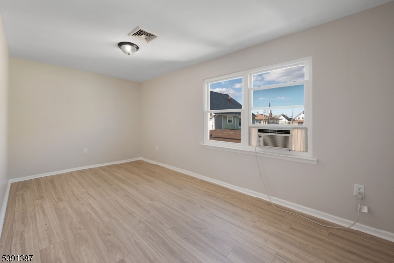 566 2nd Avenue Elizabeth, NJ 07202 - Photo 33 of 38 a view of empty room with wooden floor and fan