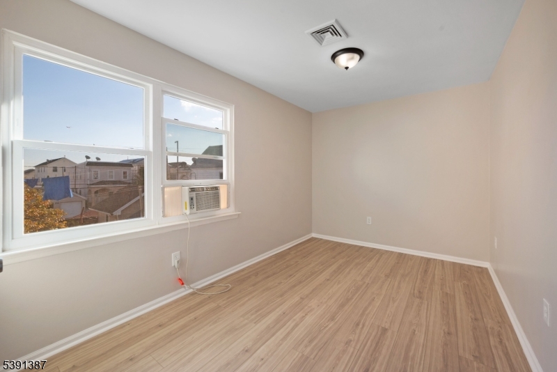 566 2nd Avenue Elizabeth, NJ 07202 - Photo 34 of 38 a view of an empty room with wooden floor and a window