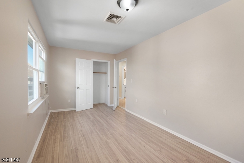 566 2nd Avenue Elizabeth, NJ 07202 - Photo 38 of 38 a view of an empty room with wooden floor and a window