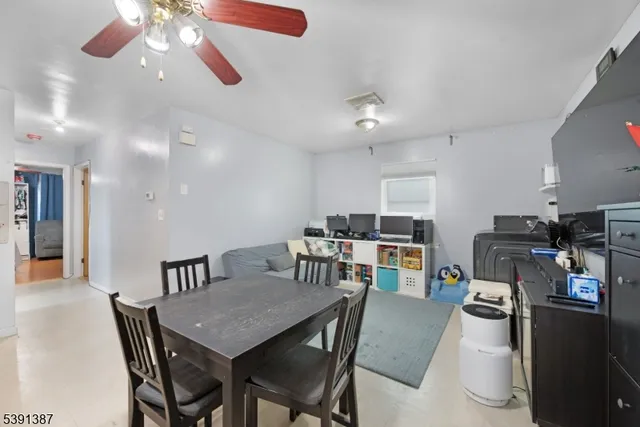 a view of a dining room with furniture and a kitchen
