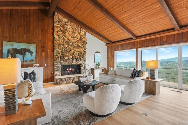 a living room with fireplace furniture and a wooden floor