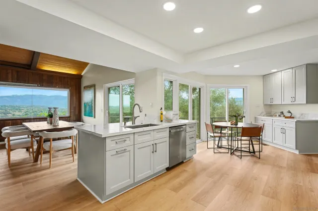 a large white kitchen with a large window