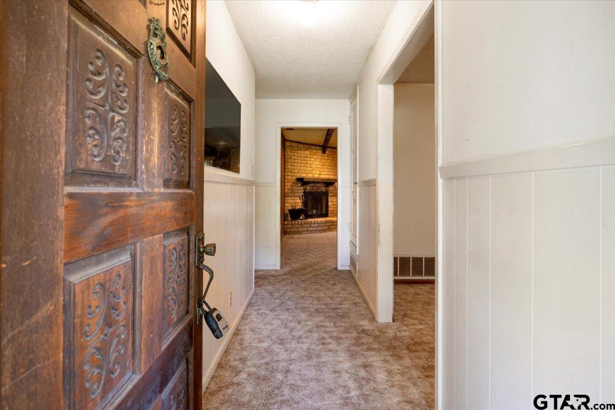 1302 Jeb Stuart Drive Tyler, TX 75703 - Photo 6 of 47 a view of a hallway with wooden shelves