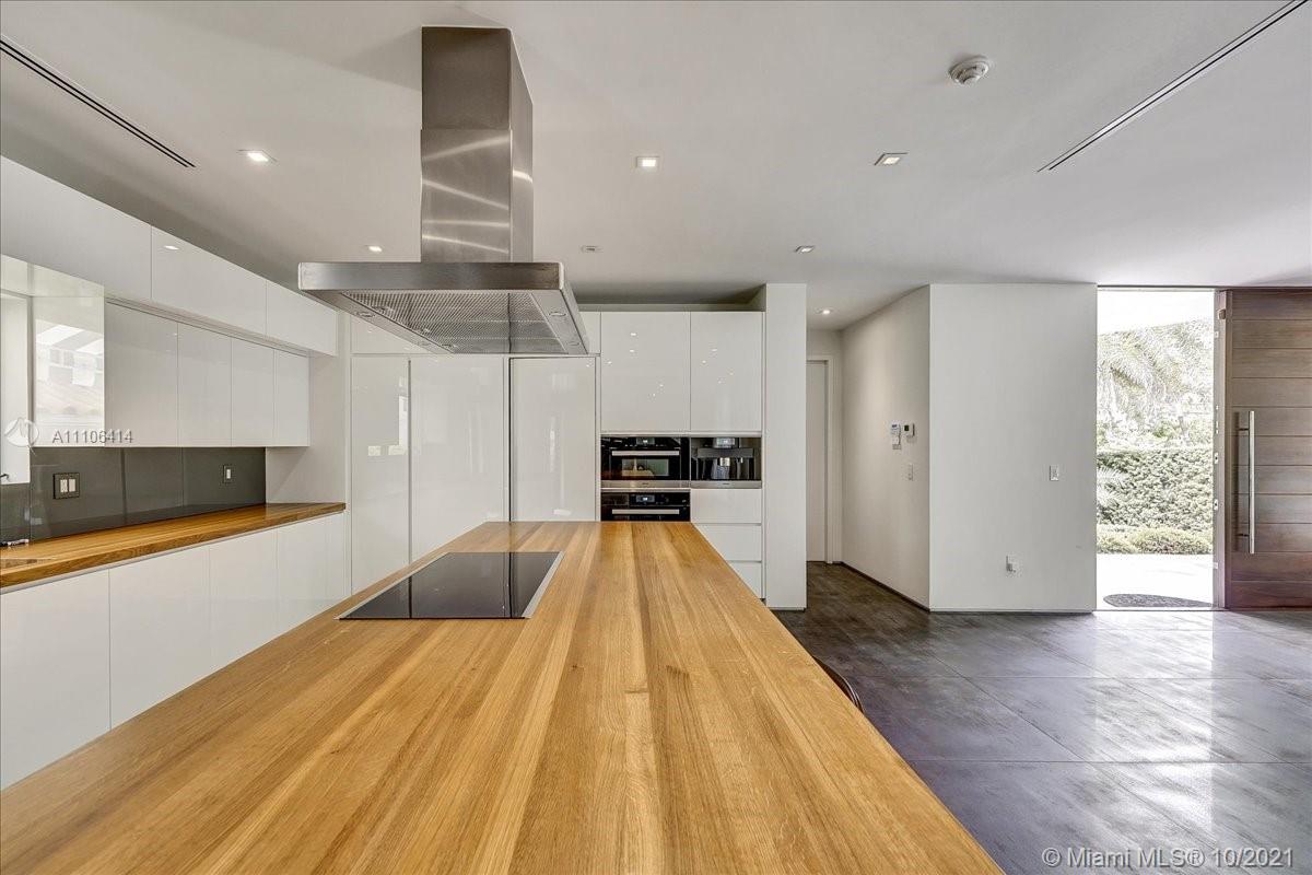 2125 North Bay Road Miami Beach, FL 33140 - Photo 16 of 71 a view of a kitchen with a sink and a refrigerator
