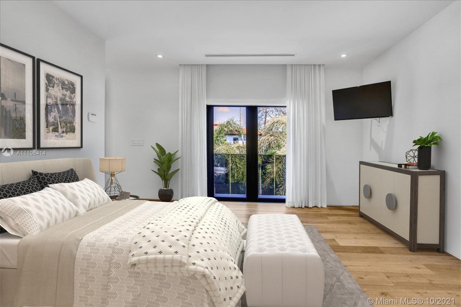 2125 North Bay Road Miami Beach, FL 33140 - Photo 27 of 71 a bedroom with a large bed and a flat screen tv
