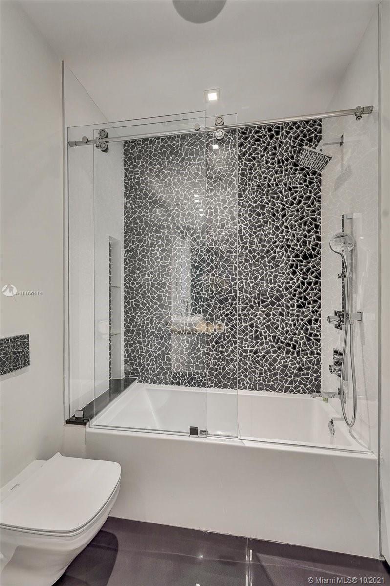 2125 North Bay Road Miami Beach, FL 33140 - Photo 50 of 71 a bathroom with a bathtub and a toilet