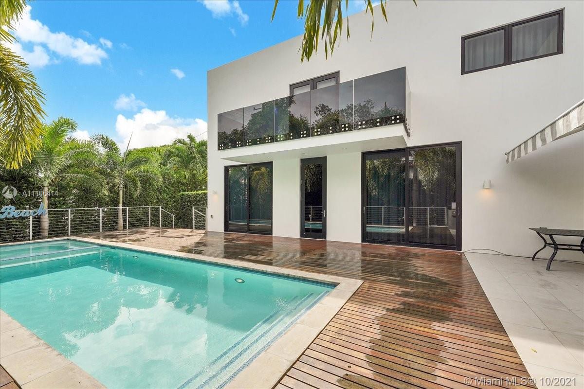 2125 North Bay Road Miami Beach, FL 33140 - Photo 59 of 71 a view of a house with a backyard and a swimming pool