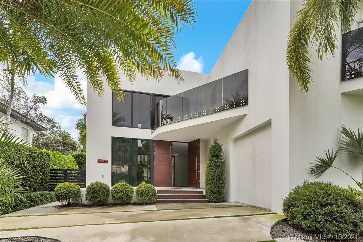 2125 North Bay Road Miami Beach, FL 33140 - Photo 7 of 71 a front view of a house with plants and palm trees