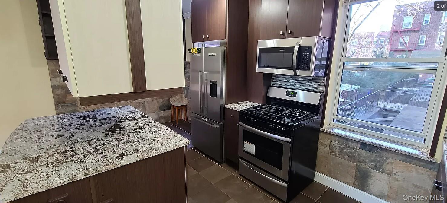 141-12 78th Road, Unit 1G Queens, NY 11367 - Photo 2 of 9 a kitchen with a stove and a refrigerator