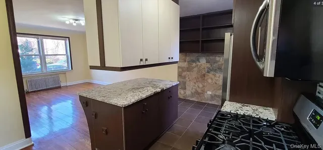 a room with wooden floor and a rug