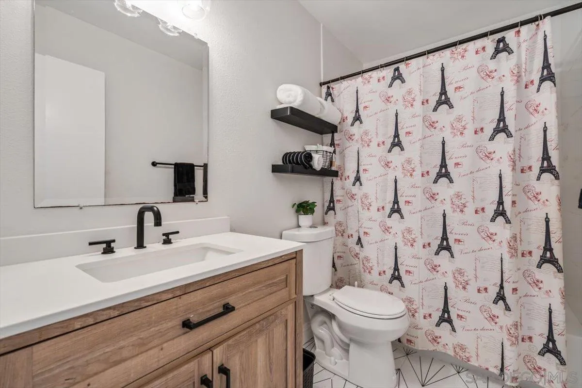 2019 Bridgeport Chula Vista, CA 91913 - Photo 14 of 32 a bathroom with a sink a toilet and a mirror