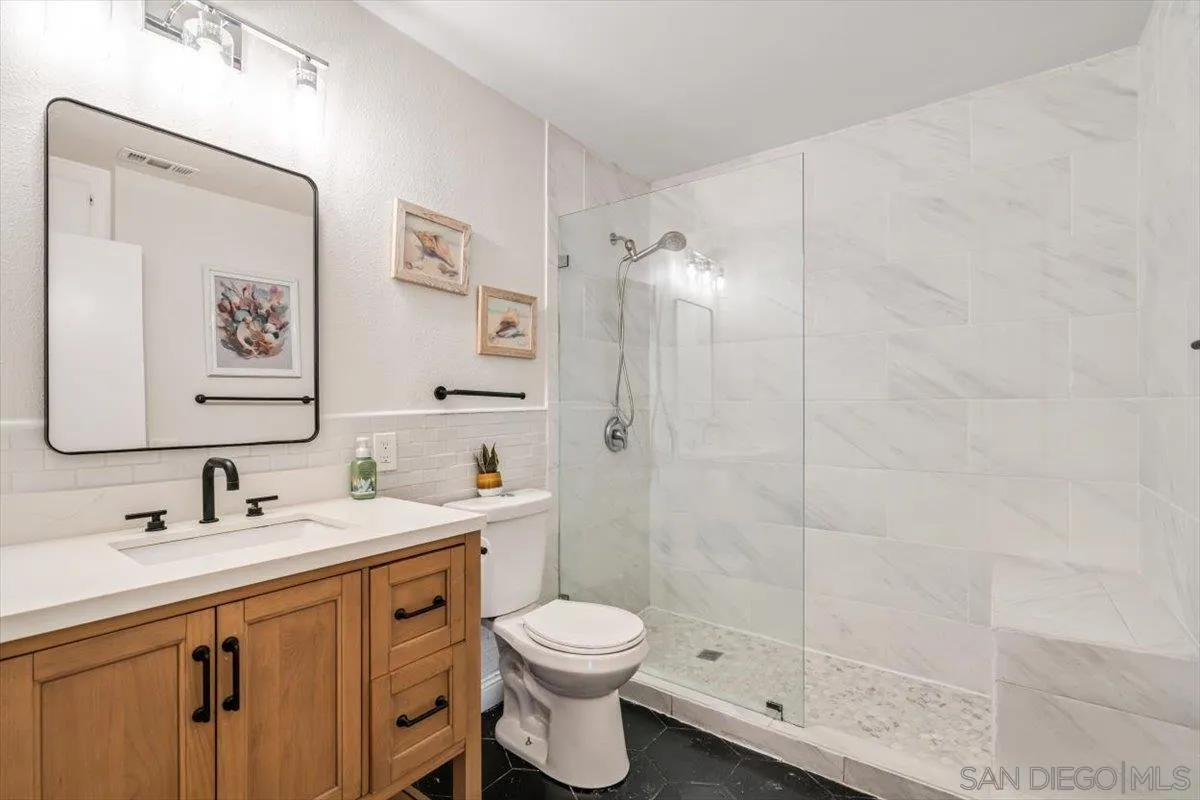 2019 Bridgeport Chula Vista, CA 91913 - Photo 17 of 32 a bathroom with a double vanity sink toilet and shower