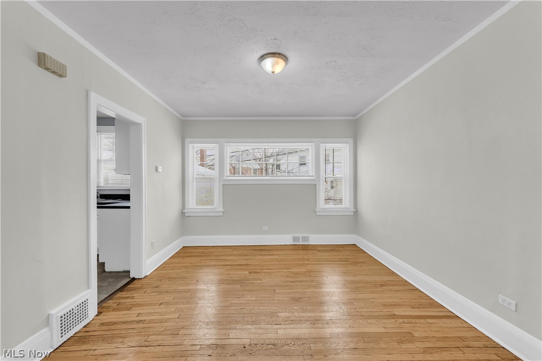 3318 Milverton Road, Unit 1/DN Shaker Heights, OH 44120 - Photo 5 of 21 This room features hardwood flooring, light grey walls, and a ceiling light fixture
