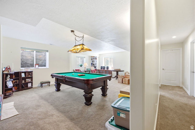 776 Flint Street Layton, UT 84041 - Photo 20 of 41 Spacious recreation room featuring neutral carpet flooring, recessed lighting, and a window with a stone-clad window well